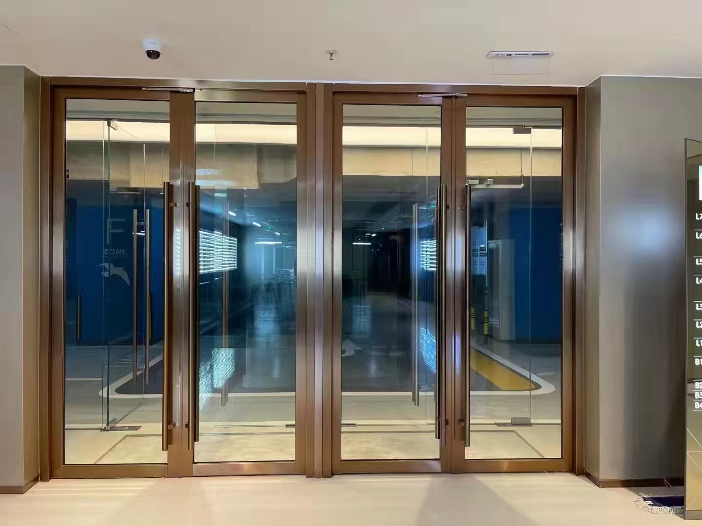 Commercial office tower lift lobby with fire-rated glass